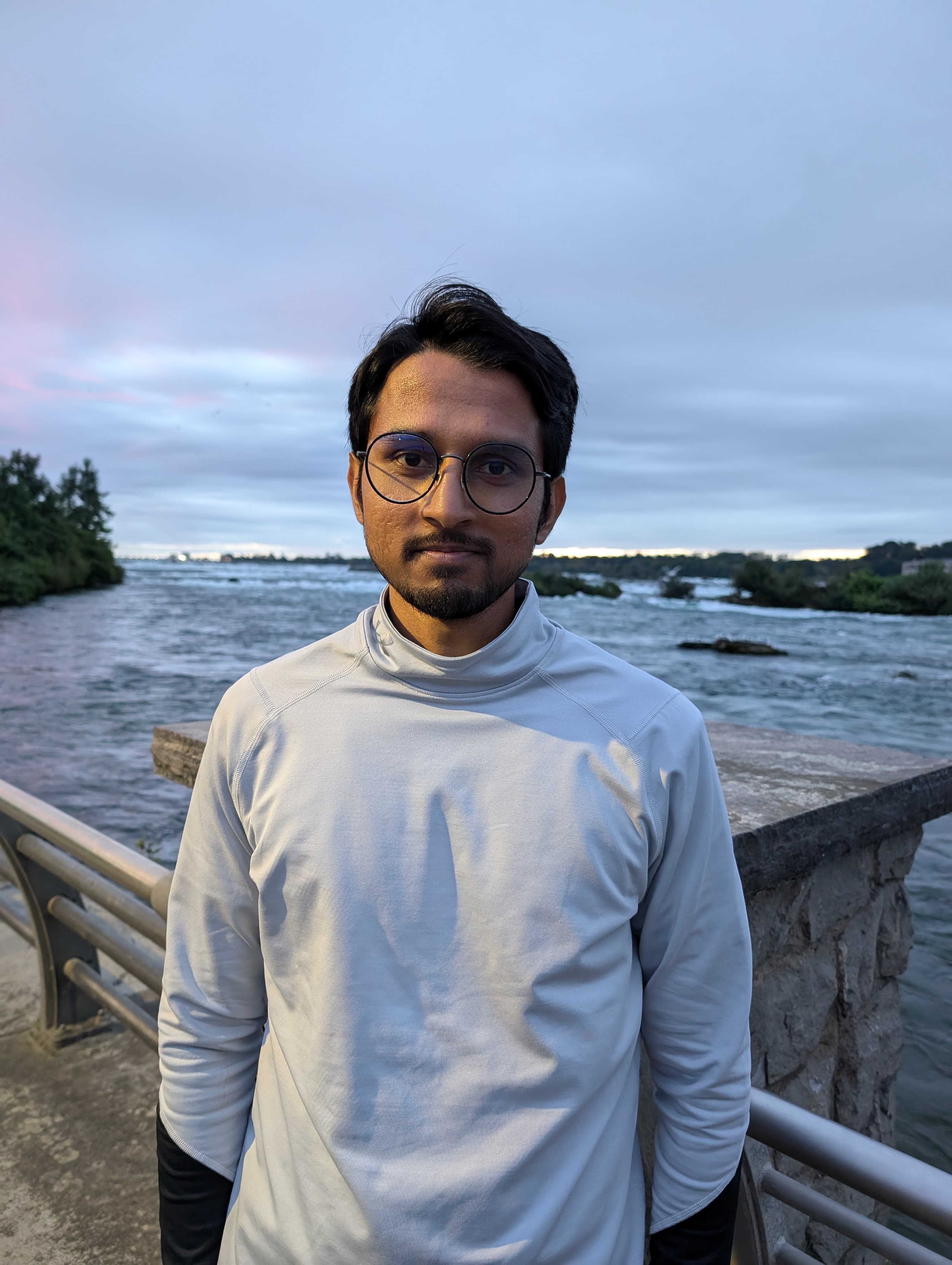 Adnan standing at the upper rapids of Niagara Falls